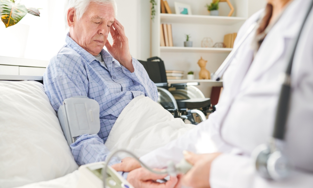Emergency room doctor monitoring hypertensive crisis patient with blood pressure and CT scan evaluation